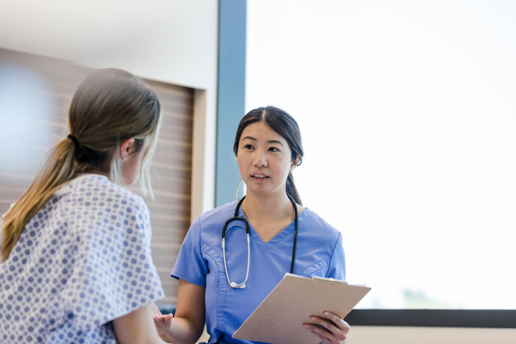 vocational nurse talking with patient in a hospital