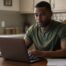 military veteran sitting at kitchen table with laptop