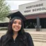 high school graduate in front of high school