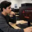 network engineer student in computer lab looking at computer with a message malware alert