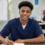 medical assistant student in class smiling at the camera