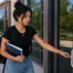 female hvac student working into front door of trade school